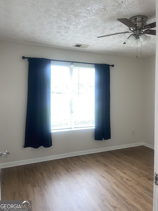 14104 Fairington Ridge Cir, Lithonia, GA 30038 - unfurnished room with a ceiling fan, wood finished floors, and a textured ceiling