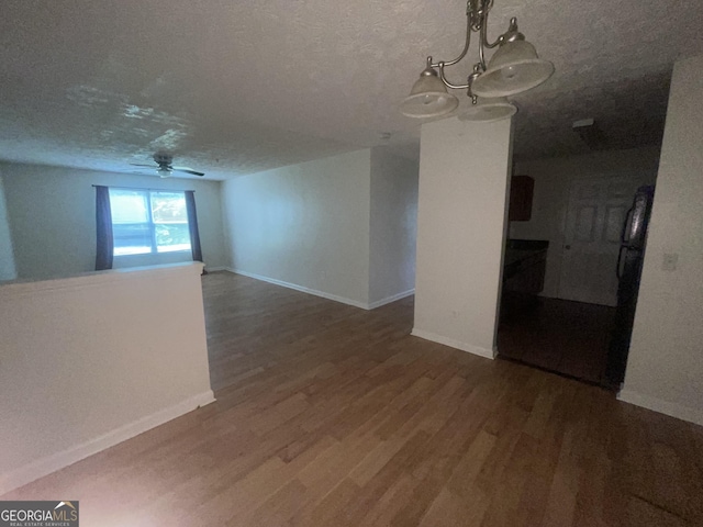 14104 Fairington Ridge Cir, Lithonia, GA 30038 - unfurnished room featuring wood finished floors, ceiling fan, a chandelier, and a textured ceiling