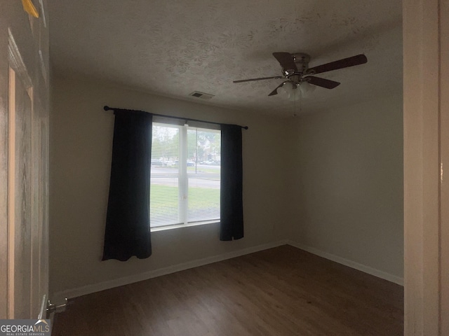 14104 Fairington Ridge Cir, Lithonia, GA 30038 - empty room with wood finished floors, a ceiling fan, and a textured ceiling