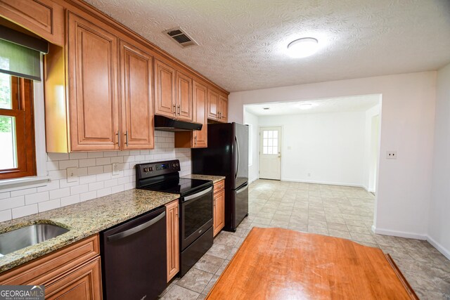 125 Point View Ct, Tyrone, GA 30290 - kitchen featuring black appliances, under cabinet range hood, decorative backsplash, light stone countertops, and a textured ceiling