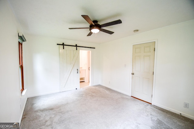 125 Point View Ct, Tyrone, GA 30290 - empty room with ceiling fan, a barn door, carpet, and a smoke detector