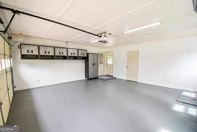 125 Point View Ct, Tyrone, GA 30290 - garage featuring a garage door opener and baseboards