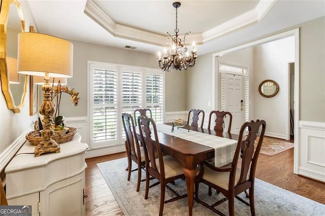 4401 Madison Woods Dr NW Unit 4401, Marietta, GA 30064 - dining space with a chandelier, a raised ceiling, crown molding, wood finished floors, and a wainscoted wall
