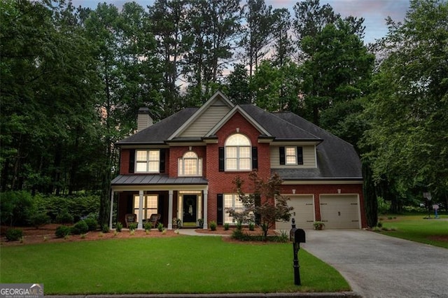 4401 Madison Woods Dr NW Unit 4401, Marietta, GA 30064 - view of front of property featuring covered porch, concrete driveway, a front yard, a chimney, and brick siding