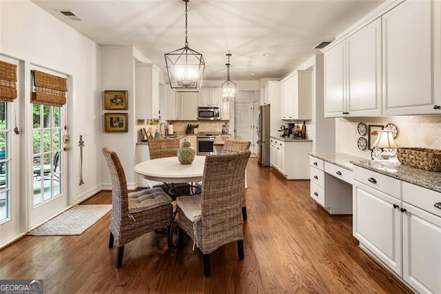 4401 Madison Woods Dr NW Unit 4401, Marietta, GA 30064 - dining room featuring dark wood-style flooring and a chandelier