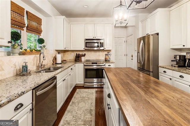 4401 Madison Woods Dr NW Unit 4401, Marietta, GA 30064 - kitchen featuring stainless steel appliances, wooden counters, dark wood-type flooring, and white cabinets