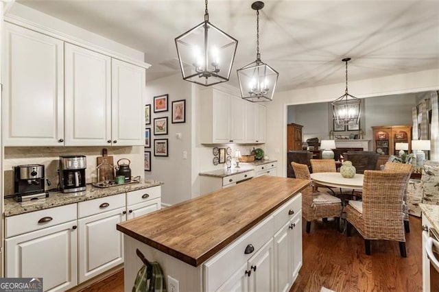 4401 Madison Woods Dr NW Unit 4401, Marietta, GA 30064 - kitchen with a chandelier, wood counters, a center island, and dark wood-type flooring