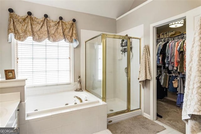 4401 Madison Woods Dr NW Unit 4401, Marietta, GA 30064 - full bath featuring a jetted tub, a stall shower, lofted ceiling, a spacious closet, and tile patterned flooring