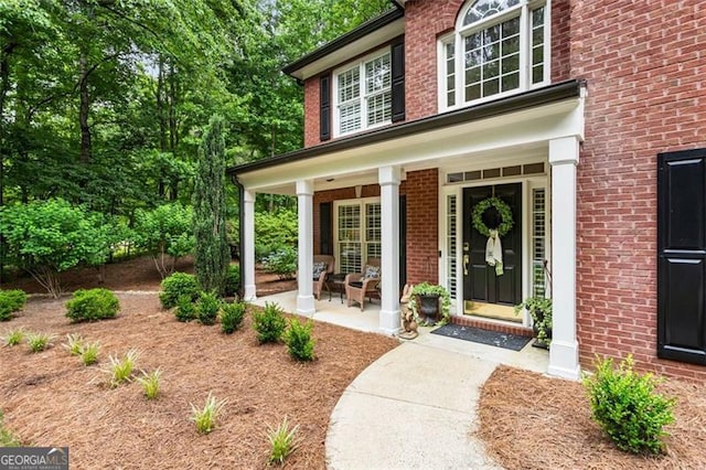 4401 Madison Woods Dr NW Unit 4401, Marietta, GA 30064 - view of exterior entry with a porch and brick siding
