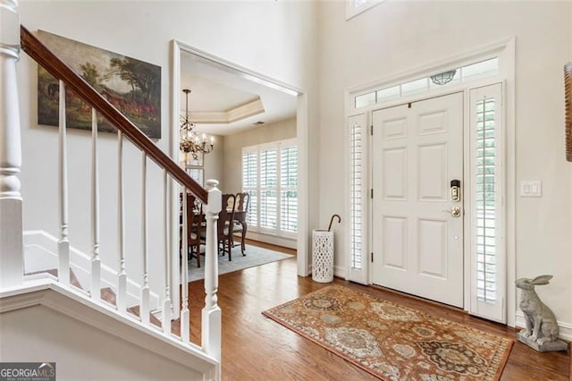 4401 Madison Woods Dr NW Unit 4401, Marietta, GA 30064 - entrance foyer with a chandelier, wood finished floors, stairs, and a raised ceiling
