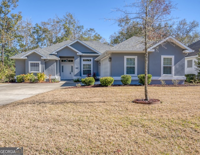 112 Justin Cole Dr, Kingsland, GA 31548 - single story home featuring stucco siding, a front lawn, and roof with shingles