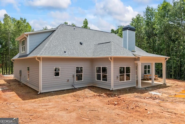 558 Holman Autry Rd, Danielsville, GA 30633 - back of house featuring a patio area, roof with shingles, and a chimney