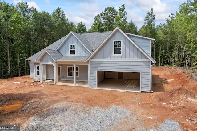 558 Holman Autry Rd, Danielsville, GA 30633 - modern farmhouse style home with roof with shingles, board and batten siding, driveway, covered porch, and a garage
