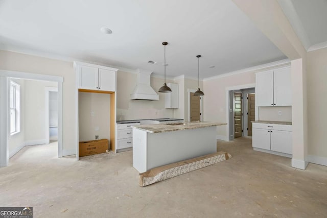 558 Holman Autry Rd, Danielsville, GA 30633 - kitchen featuring wall chimney range hood, white cabinets, a kitchen island, and ornamental molding
