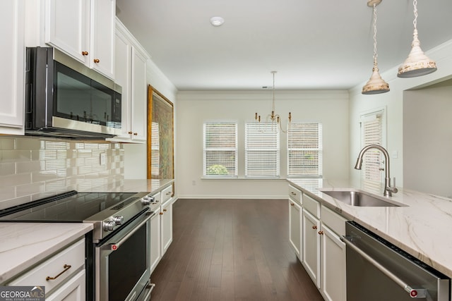 4583 Grenadine Cir, Acworth, GA 30101 - kitchen with appliances with stainless steel finishes, decorative backsplash, white cabinets, decorative light fixtures, and light stone countertops