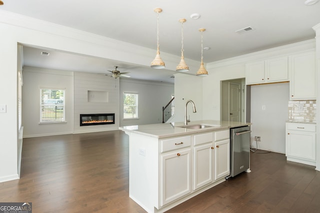 4583 Grenadine Cir, Acworth, GA 30101 - kitchen with stainless steel dishwasher, dark wood-type flooring, a ceiling fan, a large fireplace, and crown molding