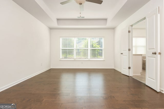 4583 Grenadine Cir, Acworth, GA 30101 - empty room featuring a tray ceiling, ceiling fan, and wood finished floors