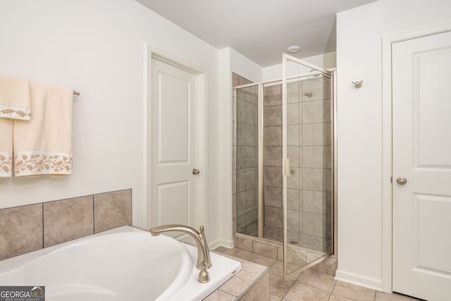 4583 Grenadine Cir, Acworth, GA 30101 - bathroom featuring a garden tub, a stall shower, and tile patterned flooring