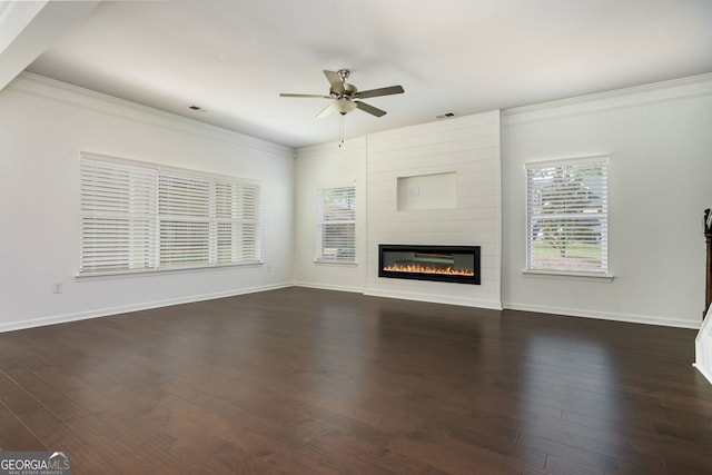 4583 Grenadine Cir, Acworth, GA 30101 - unfurnished living room featuring ceiling fan, crown molding, a large fireplace, and dark wood-style flooring