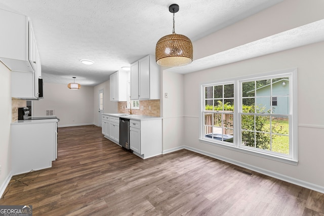223 Pinehaven Dr, Lagrange, GA 30240 - kitchen with dishwasher, light countertops, dark wood-style floors, decorative backsplash, and white cabinetry