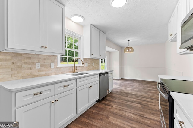 223 Pinehaven Dr, Lagrange, GA 30240 - kitchen featuring appliances with stainless steel finishes, decorative backsplash, dark wood-type flooring, light countertops, and white cabinets