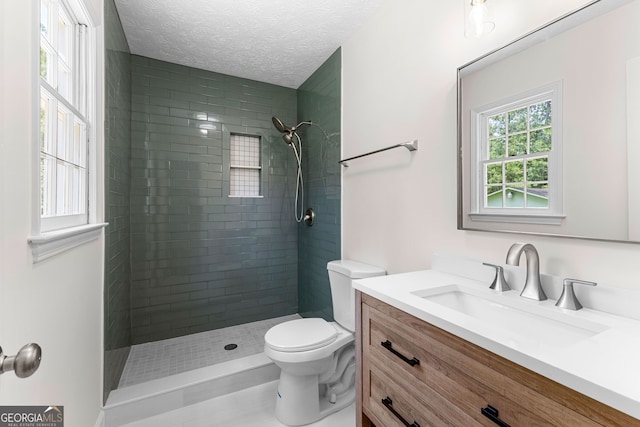 223 Pinehaven Dr, Lagrange, GA 30240 - bathroom featuring vanity, a tile shower, and a textured ceiling
