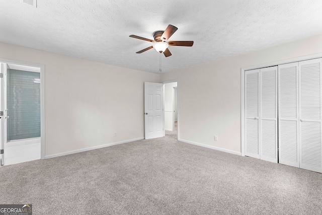 223 Pinehaven Dr, Lagrange, GA 30240 - unfurnished bedroom featuring carpet, a closet, a textured ceiling, ensuite bath, and a ceiling fan