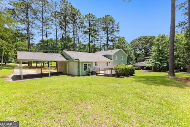 223 Pinehaven Dr, Lagrange, GA 30240 - rear view of house with a carport, a deck, a yard, and view of wooded area
