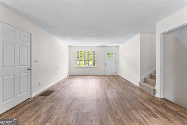 223 Pinehaven Dr, Lagrange, GA 30240 - unfurnished living room with a textured ceiling, wood finished floors, and stairway