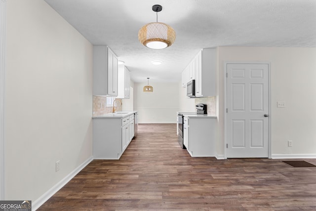223 Pinehaven Dr, Lagrange, GA 30240 - kitchen featuring appliances with stainless steel finishes, backsplash, dark wood finished floors, and light countertops