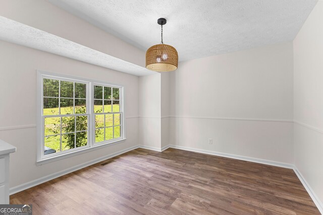 223 Pinehaven Dr, Lagrange, GA 30240 - unfurnished dining area with a textured ceiling and wood finished floors