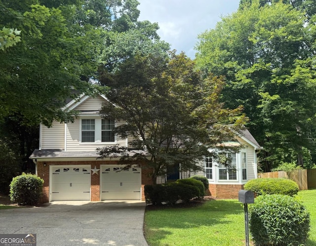 1035 Towne Manor Ct NW, Kennesaw, GA 30144 - obstructed view of property with a garage, concrete driveway, and brick siding