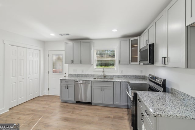 4179 Hanes Dr, Decatur, GA 30035 - kitchen featuring stainless steel appliances, recessed lighting, gray cabinetry, and light stone countertops