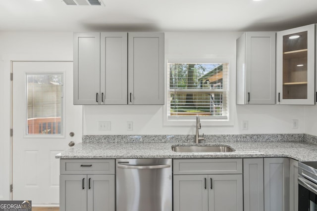 4179 Hanes Dr, Decatur, GA 30035 - kitchen with stainless steel dishwasher and gray cabinets