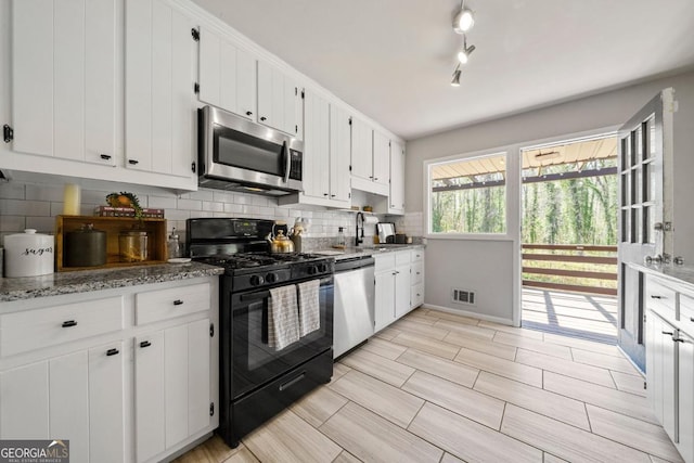 1755 Fairburn Rd SW, Atlanta, GA 30331 - kitchen featuring stainless steel appliances, backsplash, white cabinets, and wood finish floors