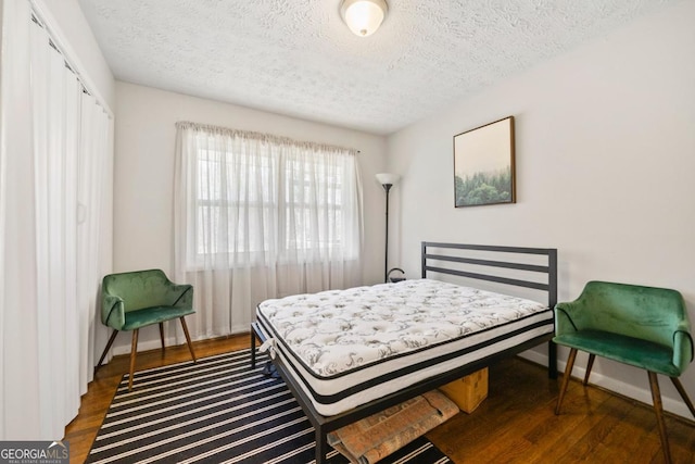 1755 Fairburn Rd SW, Atlanta, GA 30331 - bedroom featuring a textured ceiling, a closet, and dark wood finished floors