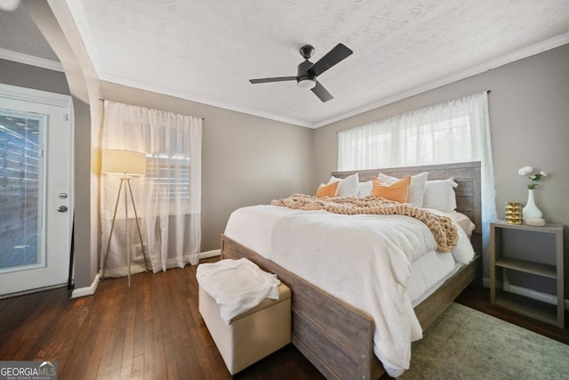 1755 Fairburn Rd SW, Atlanta, GA 30331 - bedroom with dark wood-style flooring, a textured ceiling, crown molding, and ceiling fan
