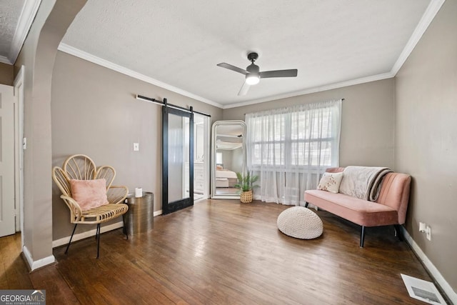 1755 Fairburn Rd SW, Atlanta, GA 30331 - sitting room featuring a barn door, wood finished floors, crown molding, and a ceiling fan