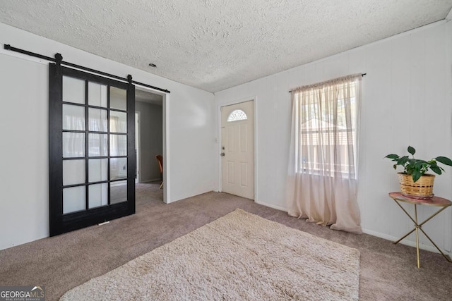 1755 Fairburn Rd SW, Atlanta, GA 30331 - entryway featuring a barn door, carpet flooring, and a textured ceiling
