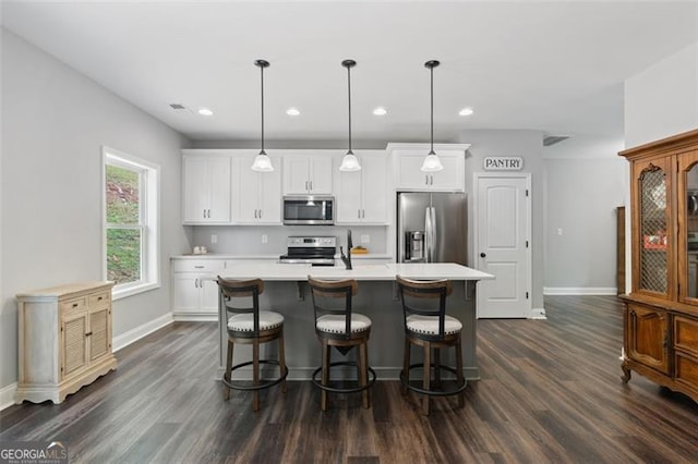 2716 Taylorsville Rd, Taylorsville, GA 30178 - kitchen with appliances with stainless steel finishes, dark wood finished floors, light countertops, a center island with sink, and recessed lighting