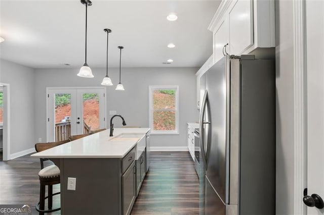2716 Taylorsville Rd, Taylorsville, GA 30178 - kitchen with freestanding refrigerator, a breakfast bar, a kitchen island with sink, french doors, and light countertops