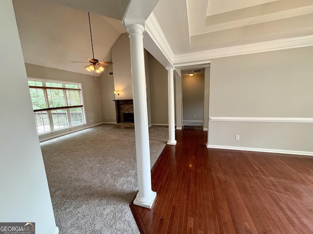 237 Shockley Way, Dallas, GA 30157 - spare room featuring ornate columns, ceiling fan, a fireplace with raised hearth, wood finished floors, and crown molding