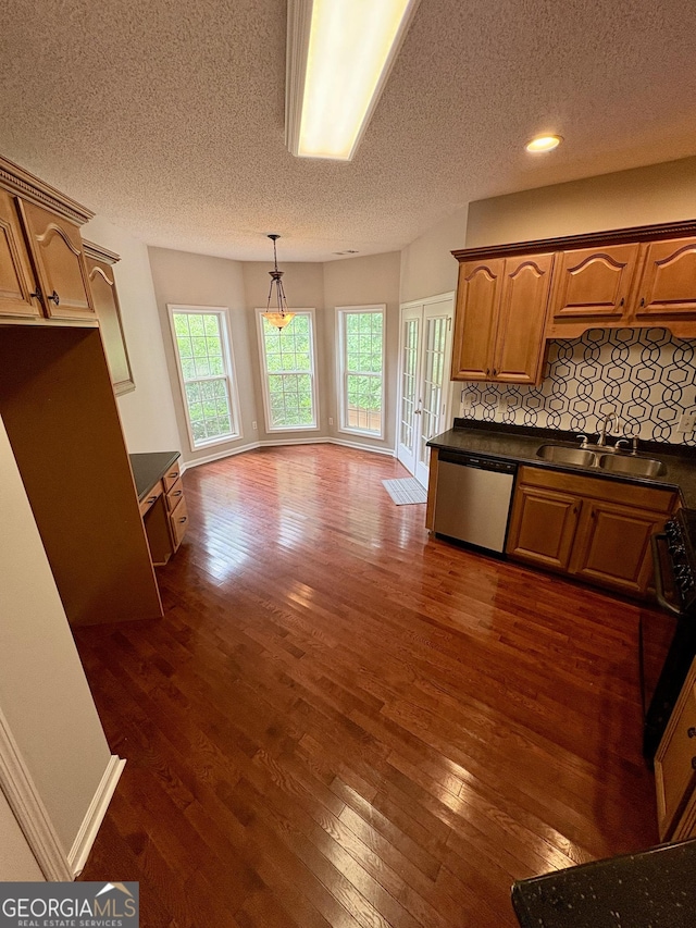 237 Shockley Way, Dallas, GA 30157 - kitchen featuring stainless steel dishwasher, dark countertops, a textured ceiling, dark wood-type flooring, and decorative backsplash