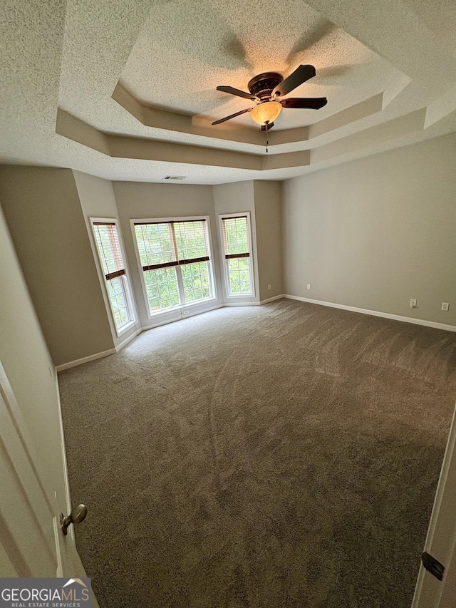 237 Shockley Way, Dallas, GA 30157 - unfurnished room featuring a tray ceiling, a textured ceiling, dark carpet, and ceiling fan