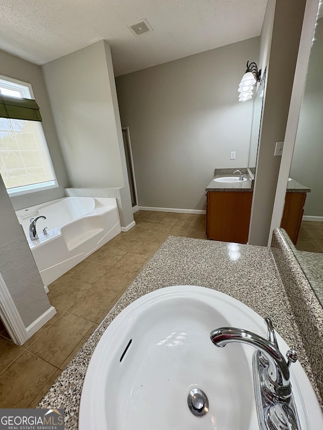 237 Shockley Way, Dallas, GA 30157 - bathroom featuring vanity, tile patterned floors, a bath, and a textured ceiling
