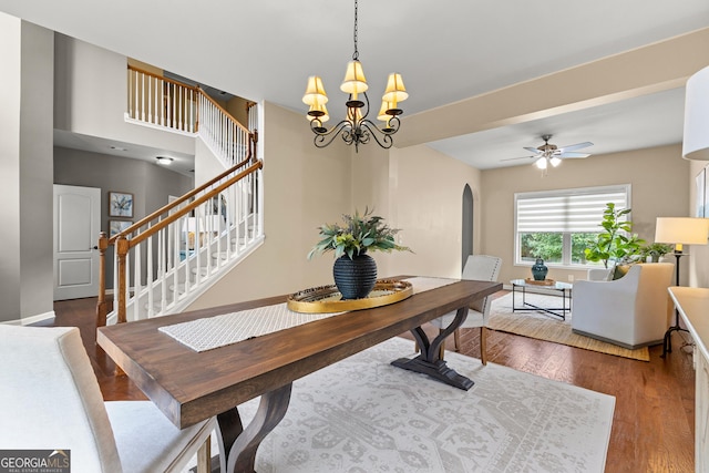 51 Stonebridge Way, Newnan, GA 30265 - dining room with arched walkways, wood finished floors, stairway, a chandelier, and a ceiling fan