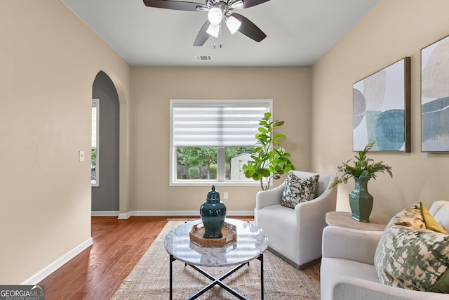 51 Stonebridge Way, Newnan, GA 30265 - living room with arched walkways, healthy amount of natural light, ceiling fan, and wood finished floors