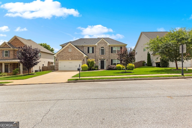 51 Stonebridge Way, Newnan, GA 30265 - view of front facade featuring driveway, brick siding, an attached garage, and a front yard