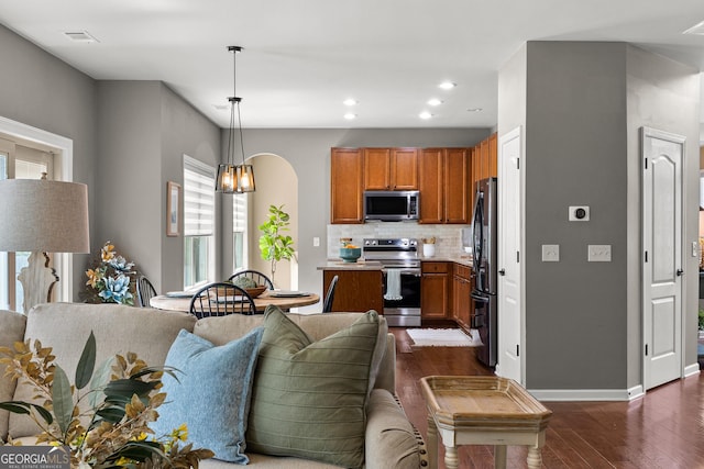51 Stonebridge Way, Newnan, GA 30265 - living room featuring dark wood-type flooring, arched walkways, and recessed lighting