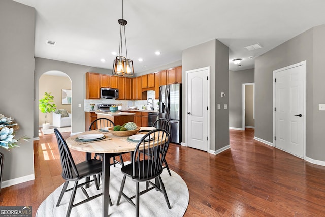 51 Stonebridge Way, Newnan, GA 30265 - dining room with arched walkways, dark wood finished floors, and recessed lighting